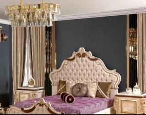 a bedroom with a large bed with purple sheets at The Empress Palace Hotel in Surrey