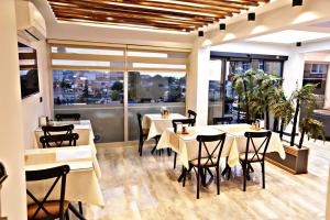 a restaurant with tables and chairs and windows at Green Nazar Hotel in Trabzon