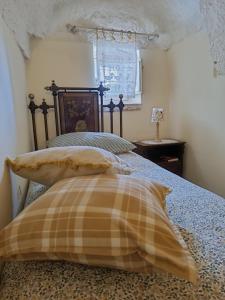 una camera con un letto con due cuscini sopra di Trullo Galeotto a Martina Franca