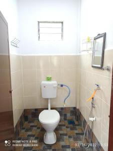 a bathroom with a white toilet in a room at Teratak Yoi in Pantai Cenang