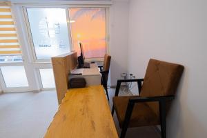 an office with a desk with a computer and a chair at Sun Shine Hotel in Durrës