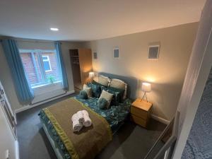 a small bedroom with a bed and a window at Pheasant lodge - Balmaha 3 bed in Glasgow