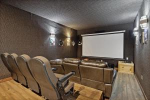 a cinema room with leather chairs and a white screen at Mystical Creek Pool Lodge #600 in Cosby