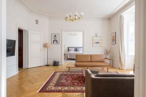 a living room with a couch and a rug at Lovely 3BR Manor Flat 5 min from Tivoli Gardens in Copenhagen