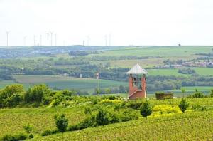 a small tower in the middle of a green field at Castillo in Ensheim +6 photos