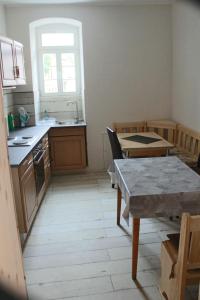 a kitchen with a table and a sink and a table and a tablektop at Castillo in Ensheim