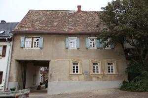 an old house with blue shuttered windows on it at Castillo in Ensheim