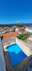 a large blue swimming pool on top of a building at Apartments Villa Bella Vista Hvar in Hvar
