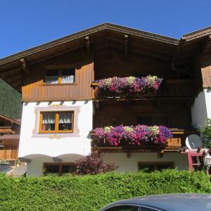 a building with flower boxes on the side of it at Haus Troger in Milders
