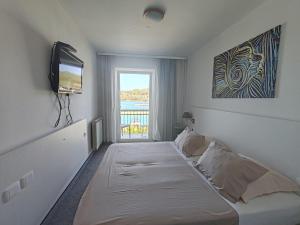 Postel nebo postele na pokoji v ubytování Hotel Dalmacija