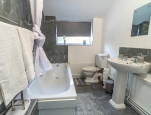 a bathroom with a sink and a tub and a toilet at Beautiful Home near City Centre in Nottingham