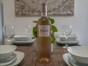 a bottle of wine sitting on a wooden table at Beautiful Home near City Centre in Nottingham