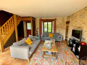 a living room with a couch and a coffee table at Maison avec jardin - L'Orangerie in Thouaré-sur-Loire