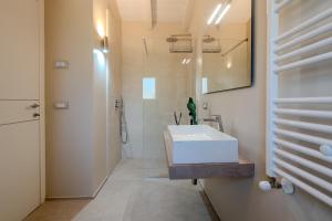 a bathroom with a white sink and a shower at Villa DEG Vista Mare San Teodoro Puntaldia in San Teodoro +28 photos
