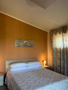 a bedroom with a large bed with yellow walls at ROOM365 in Lanciano