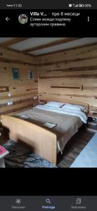 a large bed in a room with wooden walls at Vila VRABAC in Priboj +18 photos