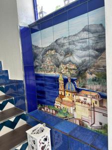 a mural of a city on a wall in a room at la divina bed&breakfast in Battipaglia