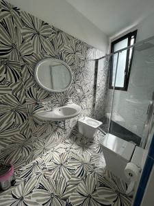 a bathroom with a sink and a mirror at la divina bed&breakfast in Battipaglia