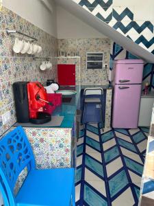 a doll house kitchen with blue and pink appliances at la divina bed&breakfast in Battipaglia +37 photos