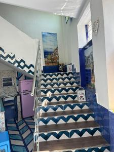 a staircase in a house with blue and white tiles at la divina bed&breakfast in Battipaglia