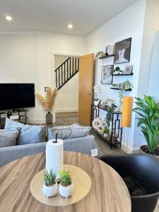 a living room with a couch and a table at JayGees luxury homes in Lower Gornal