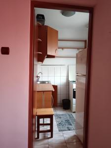 a kitchen with a sink and a table and a counter at Apartament 1 camera zona liniștită in Drobeta-Turnu Severin