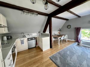 a kitchen with white appliances and a table in a room at The Loft @ Brighouse in Brighouse