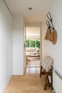 a hallway with a living room with a couch at Chalet Boisée in Voorthuizen
