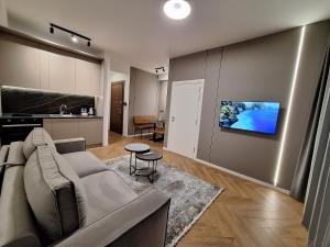 a living room with a couch and a kitchen at Modern Living Apartments in Skopje