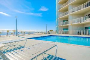 a swimming pool in a hotel with a view of the ocean at Sea Breeze 1011 Penthouse in Biloxi