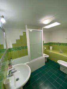 a bathroom with a sink and a shower and a toilet at ATTICO con TERRAZZO panoramico MAIELLA - 1piano - VASTO in Vasto