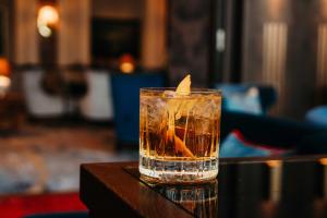 a candle in a glass on a table at Hotel Atlantic Hamburg, Autograph Collection in Hamburg