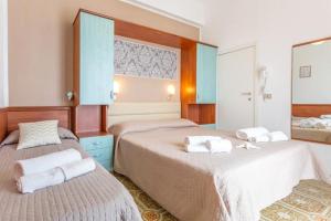 Postel nebo postele na pokoji v ubytování Hotel Ideale Mare
