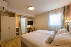 a hotel room with a bed and a desk at Residence de Tourisme Ajaccio Amirauté in Ajaccio +61 photos