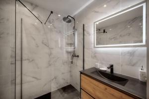 a bathroom with a sink and a glass shower at Cannes Luxury Rental - Stunning apartment with terrace to rent Grand Hotel in Cannes