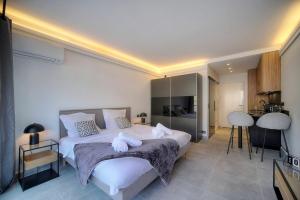 a bedroom with a large bed with towels on it at Cannes Luxury Rental - Stunning apartment with terrace to rent Grand Hotel in Cannes