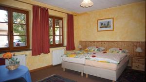 a bedroom with a large bed with red curtains at Gaestehaeuser Eva_Maria und Reinha in Hinrichshagen Hof