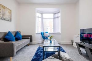 a living room with a couch and a tv at Recently renovated stylish home parking Pass the Keys in Bishop Auckland