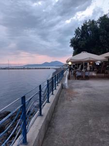a pier with tables and chairs next to the water at Seaview studio in Neapoli Voion