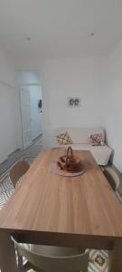 a wooden table with a sculpture on top of it at Casa Vacanze Altea in Santa Flavia