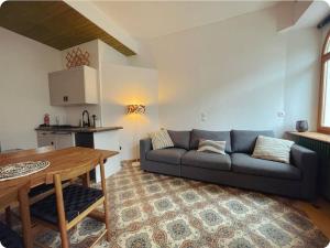 a living room with a couch and a table at Soul La Meije - Simple, Original in La Grave