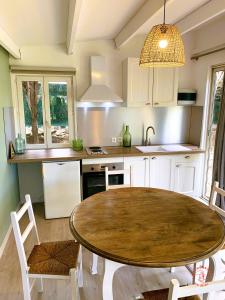 a kitchen with a large wooden table in a room at Gîte Studio Les Ecureuils in Narbonne
