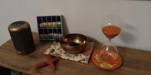 a wooden table with a clock and a wine glass at FriesenStee Unterkunft mit Infrarotsauna in Sack