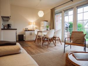 a kitchen and living room with a table and chairs at Steilufer Appartments in Timmendorfer Strand +12 photos