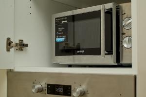 a microwave oven on a shelf in a kitchen at Skyline resort in Bečići