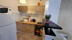a kitchen with a wooden counter top and a refrigerator at New Moment in Žarkovo