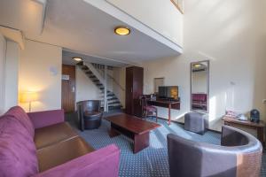 a living room with a couch and a table at Amr&acirc;th Grand Hotel de l&rsquo;Empereur in Maastricht