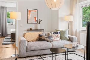 a living room with a couch and two tables at Liseberg Södra in Gothenburg