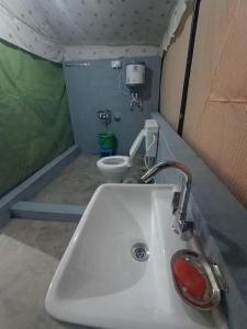 a bathroom with a sink and a toilet at DIV ADVENTURE CAMP in Dharamshala