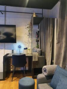 a living room with a desk and a chair at City Center Tirana Urban Condo in Tirana